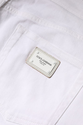 Białe bawełniane obcisłe dżinsy ze średnim stanem